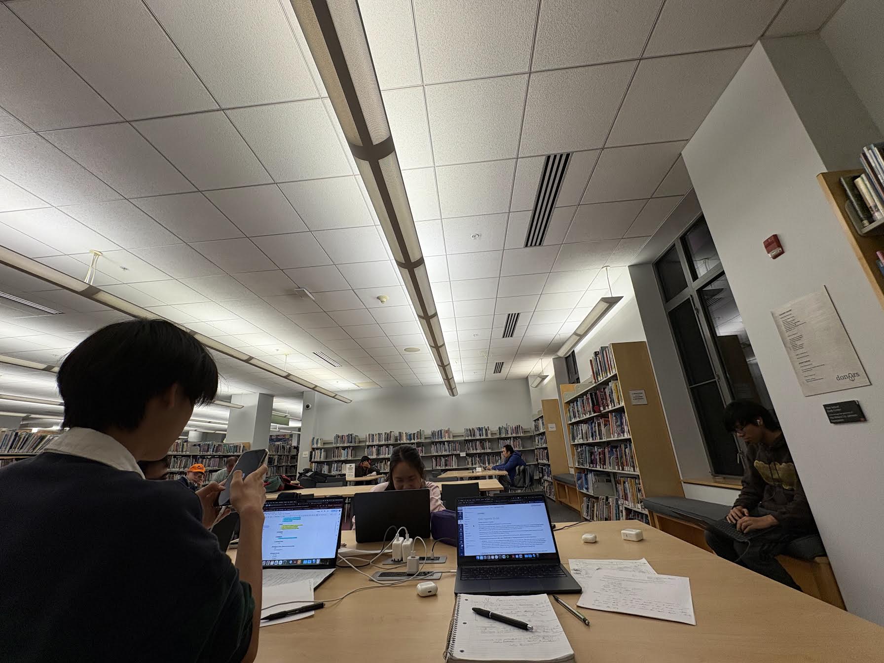 Students studying together with laptops at the library