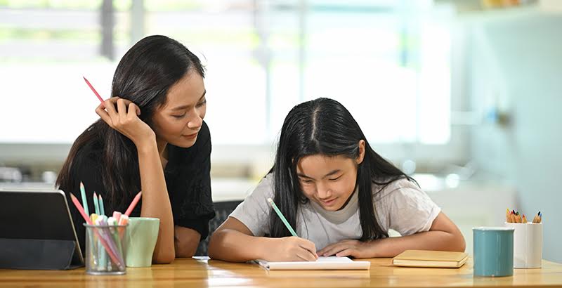 Tutor helping a student with a writing lesson